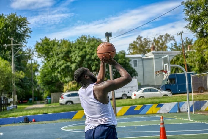 A basketball player practicing shooting