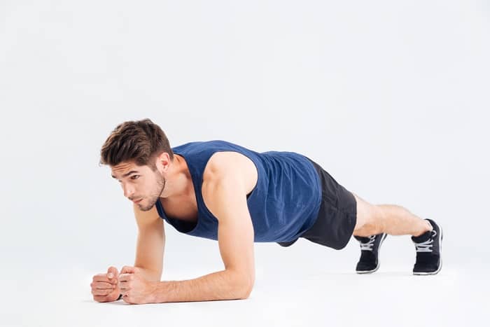 A young man doing plank exercise