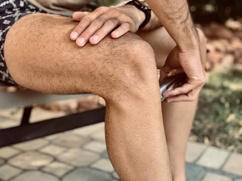 man shaving his legs