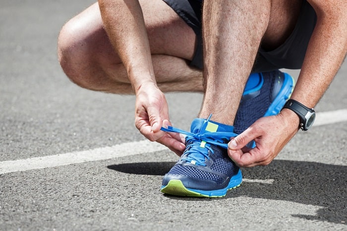 Runner trying running shoes getting ready for run.