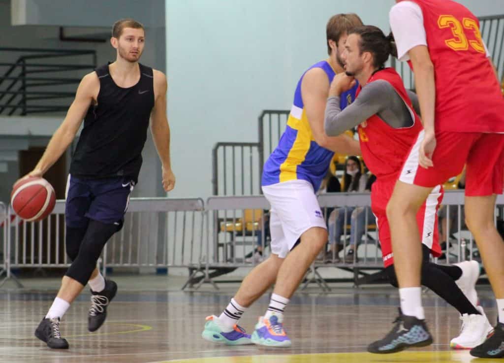 adam gotelli playing basketball on the court