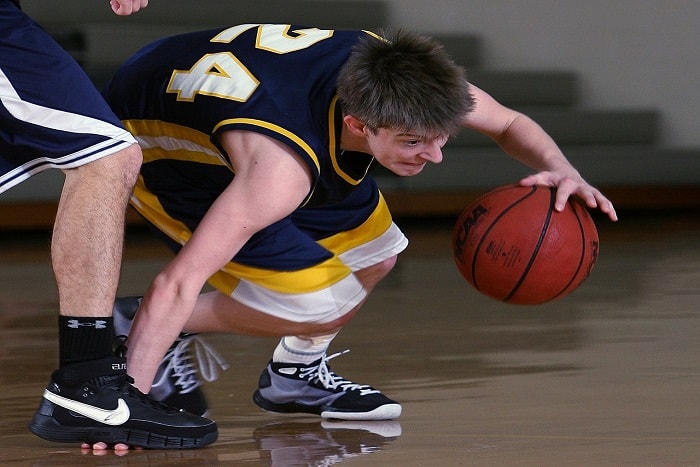 Basketball player with basketball in a game