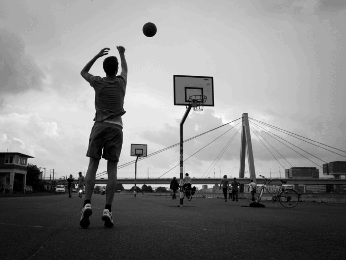 a basketball player jumping and shooting a ball