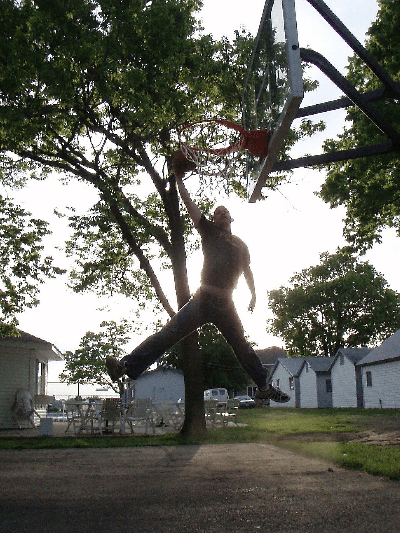 a man dunking on a portable hoop